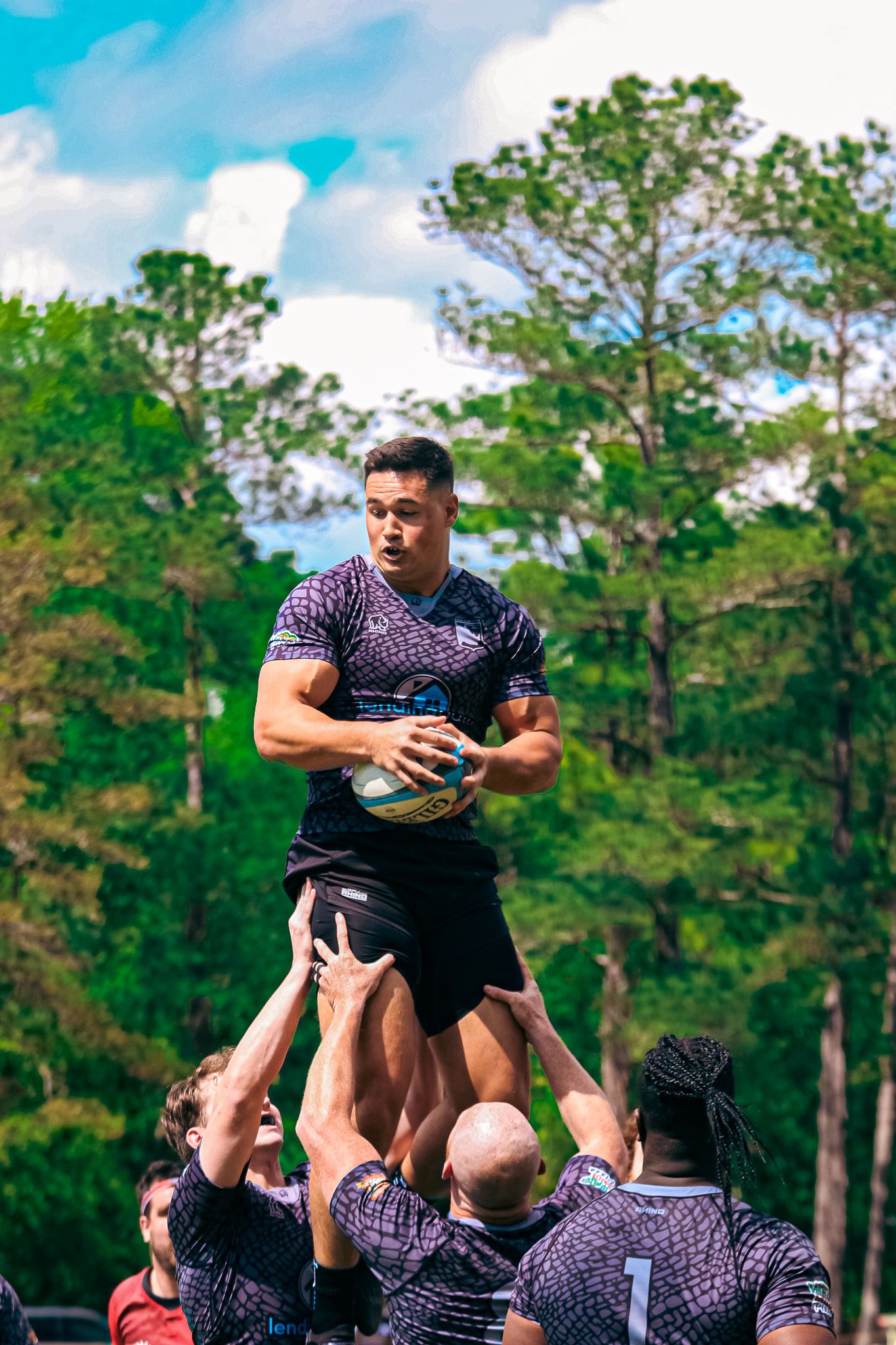 Columbia Rhinos teammates lifting a player in a lineout