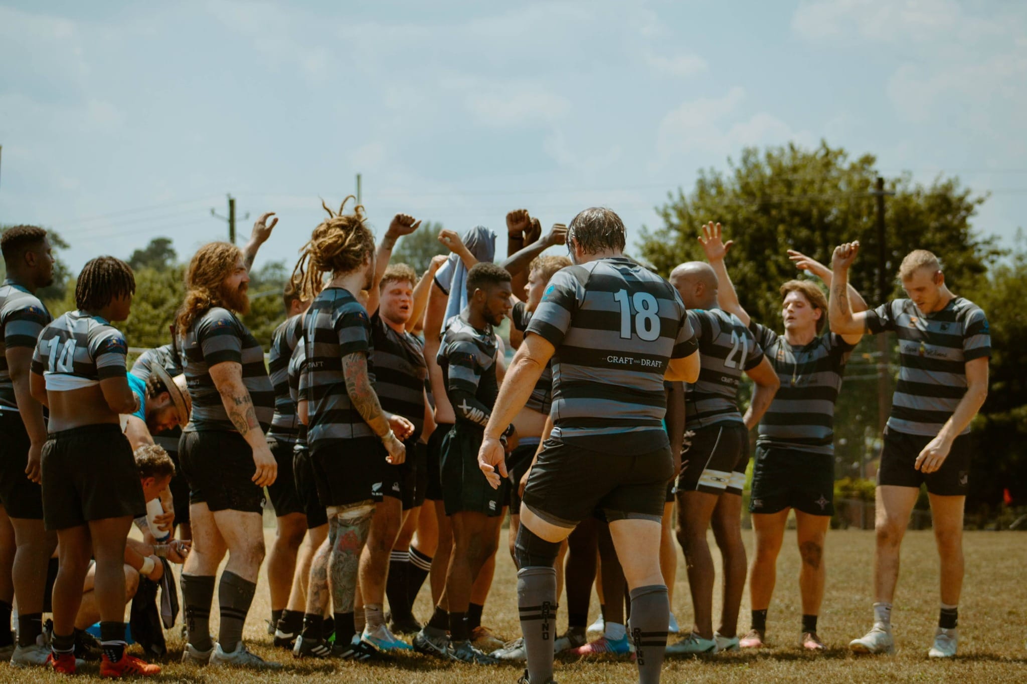 Columbia Rhinos players raising their arms together in a team huddle