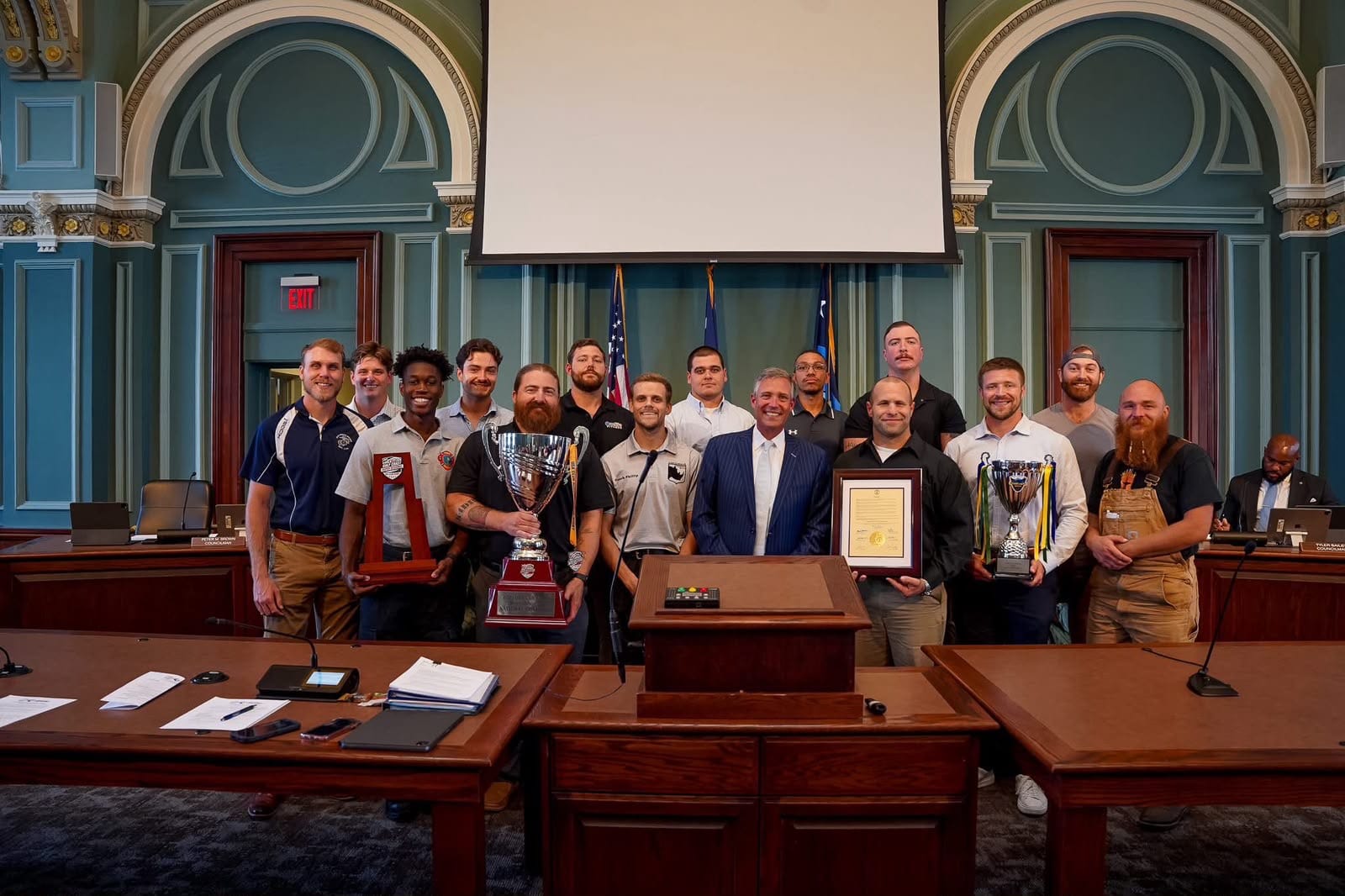 Columbia Rhinos players and city leaders displaying championship trophies at Columbia City Hall